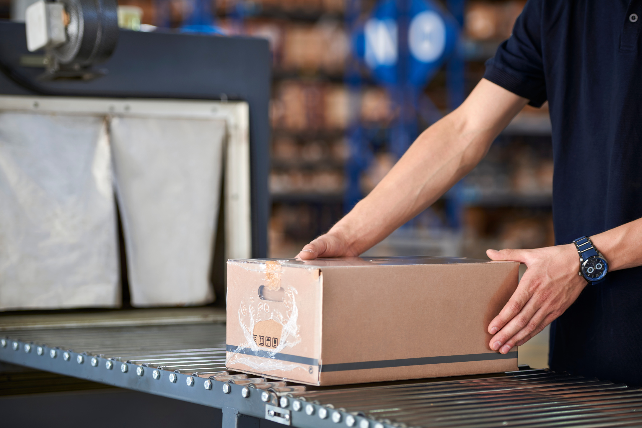 Worker packing box in warehouse