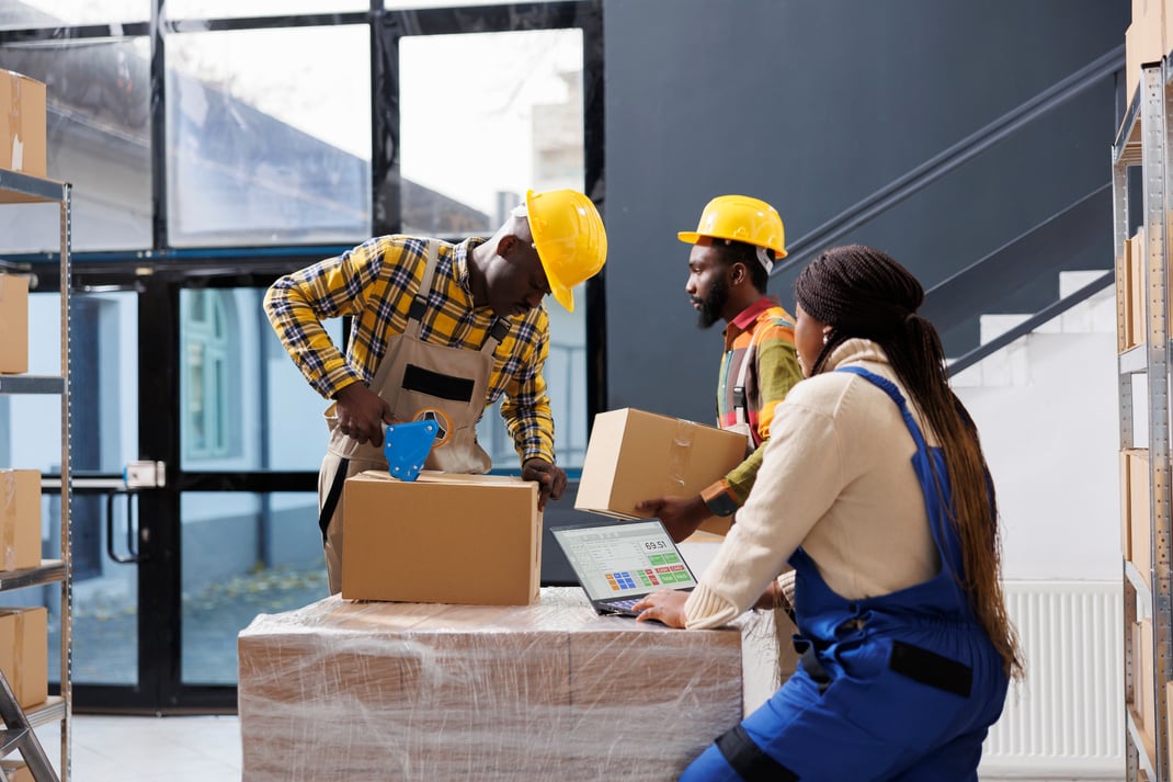 Warehouse managers team preparing customer order for delivery